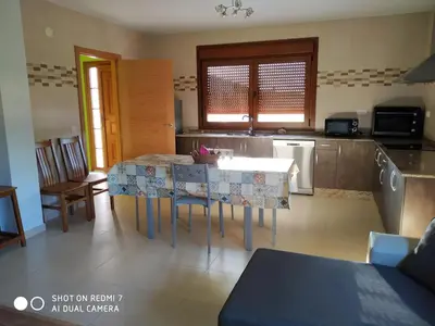 a kitchen with a table and chairs in a room at Casa Pura in Ribadeo