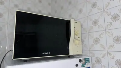 a flat screen tv sitting on top of a refrigerator at Entire apartment centro ponferrada in Ponferrada