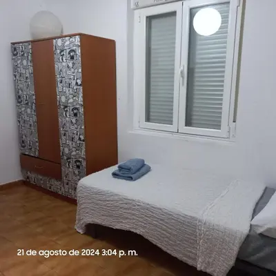 a bed in a room with a window and a bedvisor at Entire apartment centro ponferrada in Ponferrada