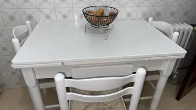a white table and chairs with a basket on it at Entire apartment centro ponferrada in Ponferrada