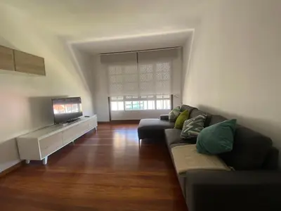 a living room with a couch and a flat screen tv at A un Paso in Caldas de Reis