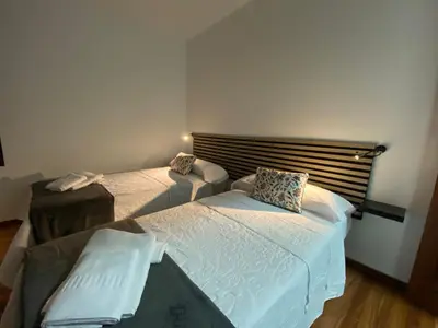 a bedroom with two twin beds in a room at La Huella de Caldas in Caldas de Reis