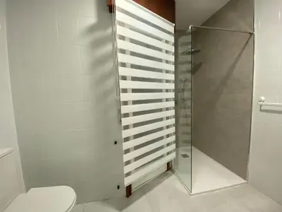 a bathroom with a toilet and a shower at La Huella de Caldas in Caldas de Reis
