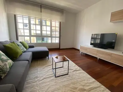 a living room with a couch and a flat screen tv at La Huella de Caldas in Caldas de Reis