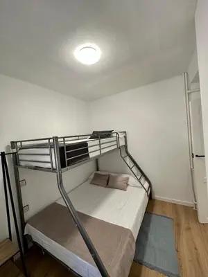 a bunk bed in a small room with a light at Alojamientos El Bierzo in Ponferrada