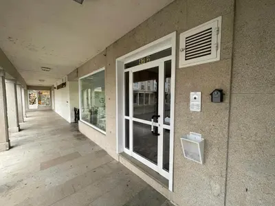 an empty hallway of a building with a window at Destino Allariz in Allariz