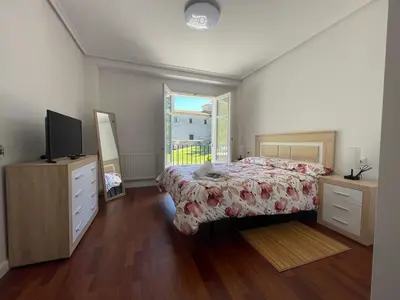 a bedroom with a bed and a television and a window at Destino Allariz in Allariz