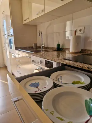 a kitchen with white plates on a counter at Casa Caldelas in Puente Caldelas