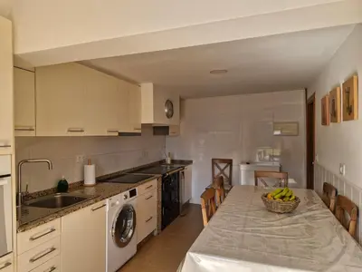 a kitchen with a table with a bowl of bananas on it at Casa Caldelas in Puente Caldelas