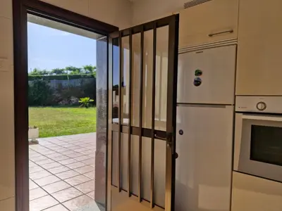 an open door to a kitchen with a refrigerator at Casa Caldelas in Puente Caldelas