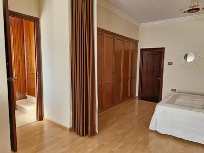 a bedroom with a bed and a wooden floor at Casa Caldelas in Puente Caldelas