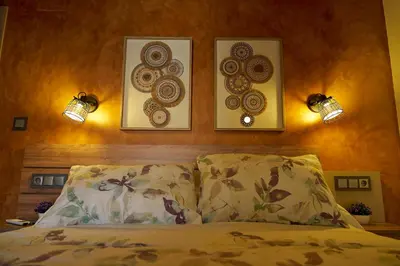 a bedroom with three pictures on the wall above a bed at O Campiño Alojamientos Turísticos in Trasmiras