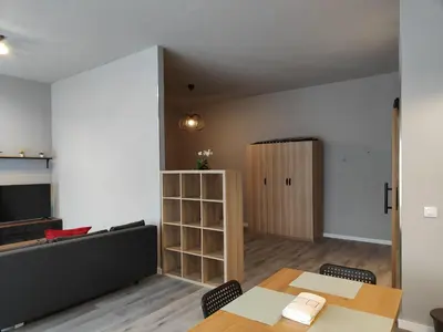 a living room with two tables and a book shelf at Lar de Yago - Apto Barreiros B in San Cosme de Barreiros