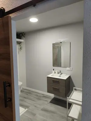 a bathroom with a sink and a mirror at Lar de Yago - Apto Barreiros B in San Cosme de Barreiros