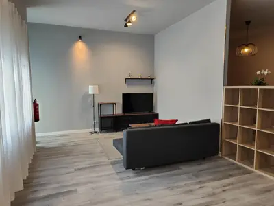 a living room with a couch and a television at Lar de Yago - Apto Barreiros B in San Cosme de Barreiros