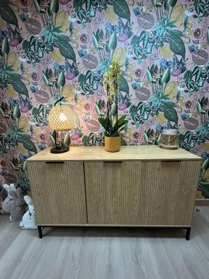 a dresser with a lamp on it in a room with a wallpaper at Apartamento Fernando III el Santo in Santiago de Compostela