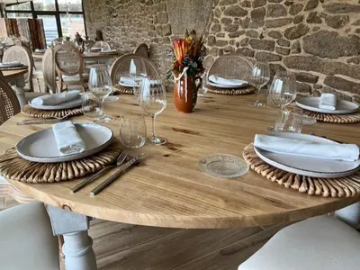 a wooden table with plates and wine glasses on it at A Casa do Pillado in Vilariño
