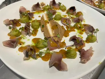 a plate of food with meat and vegetables on it at A Casa do Pillado in Vilariño