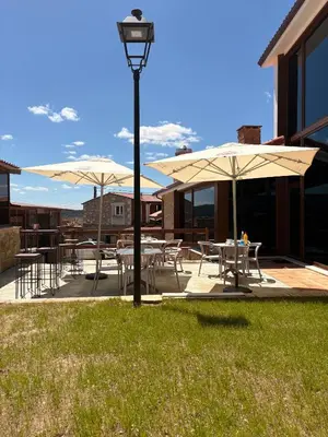 a patio with tables and chairs and umbrellas at A Casa do Pillado in Vilariño
