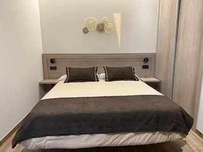 a bedroom with a large bed with two pillows at A Casa do Pillado in Vilariño