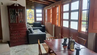 a living room with a table and a couch at Granja del Peregrino in O Pino