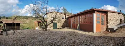 a small stone building with a small tree in front of it at Granja del Peregrino in O Pino