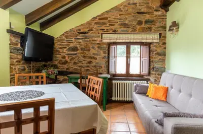 a living room with a couch and a table at Apartamentos Turisticos A Estacion in A Pontenova