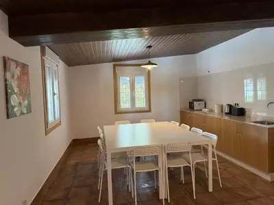 a kitchen with a table and chairs in a room at Primavera in Padrón