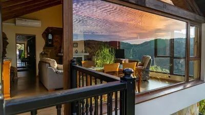 a room with a balcony with a view of the mountains at Casa El Mirador del Miño en la Ribeira Sacra in Rosende
