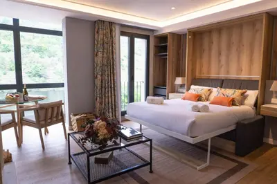 a bedroom with a bed and a table and a desk at Albariño in Pincelo