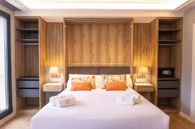 a bedroom with a large white bed with two lamps at Albariño in Pincelo