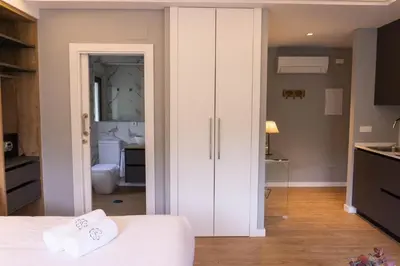 a bedroom with a white closet and a bathroom at Albariño in Pincelo