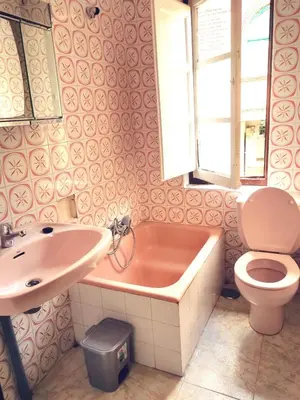 a bathroom with a tub and a toilet and a sink at Apartamento MIZA in Ponferrada