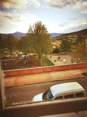 a white car parked on the side of a street at Apartamento MIZA in Ponferrada