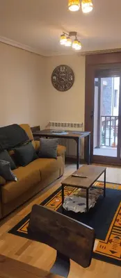 a living room with a couch and a table at La Vega De Somiedo in Pola de Somiedo