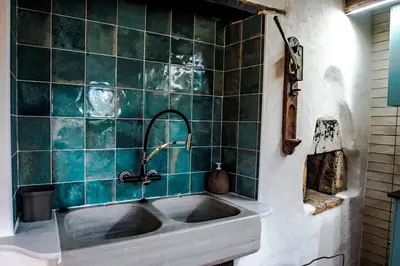 a bathroom with a sink and a green tiled wall at Casa Rural zona Playa de Frejulfe in Piñera