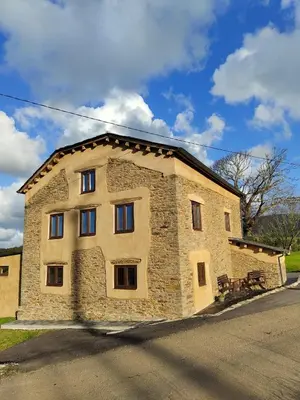 a large stone building on the side of a road at Casa Rural zona Playa de Frejulfe in Piñera