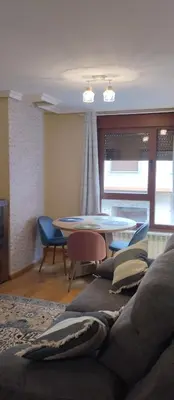 a living room with a couch and a table at La Vega De Somiedo 1 in Aguino