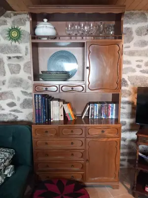 a wooden cabinet with a tv on top of it at A casa da Touza in Pensos