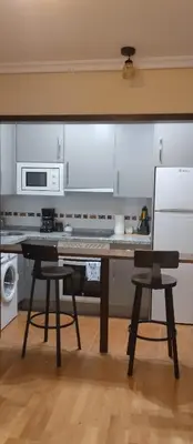 a kitchen with a table and two chairs at La Vega De Somiedo 2 in Pola de Somiedo