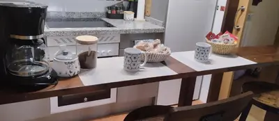 a counter with cups and baskets on it in a kitchen at La Vega De Somiedo 2 in Pola de Somiedo