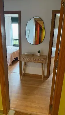 a dressing table with a mirror in a room at A Orillas de Llas in Foz