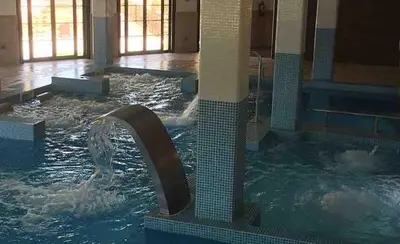 a large swimming pool with a water fountain at Apartment in Costa with Spa, Jacuzzi in San Miguel de Reinante