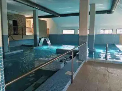 a large swimming pool with a water slide at Apartment in Costa with Spa, Jacuzzi in San Miguel de Reinante