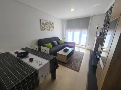a living room with a couch and a table at Apartment in Costa with Spa, Jacuzzi in San Miguel de Reinante