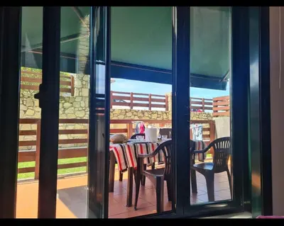 a view of a table and chairs through a window at Apartment in Costa with Spa, Jacuzzi in San Miguel de Reinante