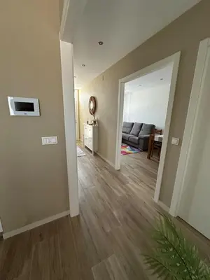 an empty living room with a couch and wood floors at Villa Doce in Puentecesures
