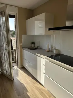 a kitchen with white cabinets and a counter top at Villa Doce in Puentecesures