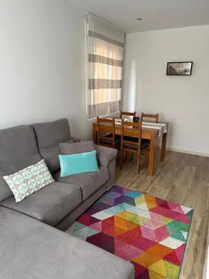 a living room with a couch and a dining room table at Villa Doce in Puentecesures
