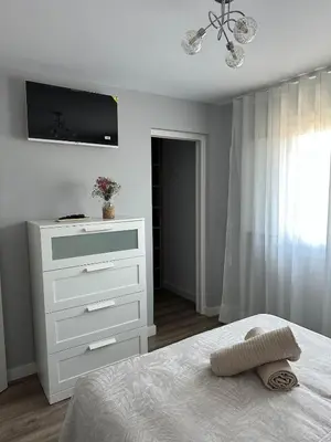 a bedroom with a bed and a dresser with a television at Villa Doce in Puentecesures